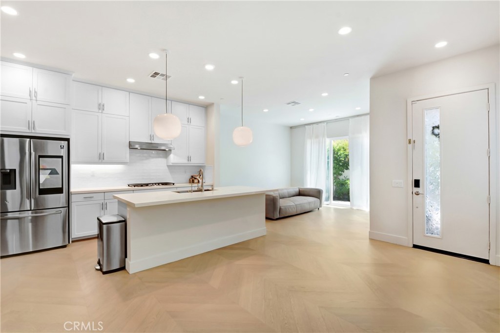 181 Novel Irvine, CA 92618 - Photo 3 of 22 a large white kitchen with a refrigerator a oven and a sink