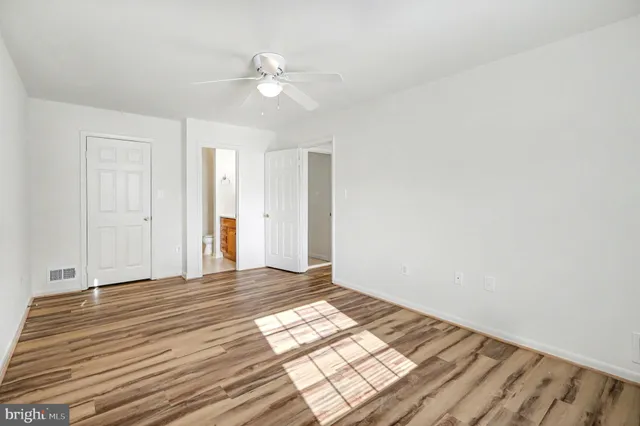 a view of an empty room with wooden floor