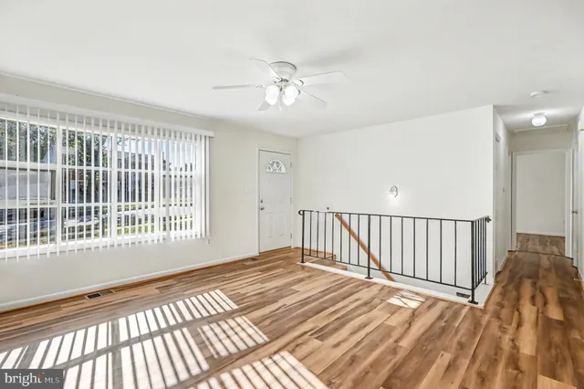 a view of a bedroom with wooden floor
