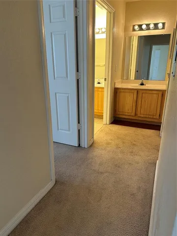 an empty room with wooden floor and cabinet