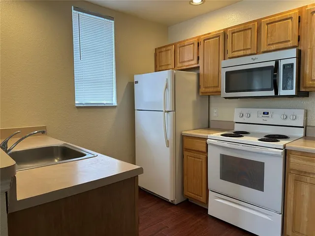a kitchen with a stove microwave and refrigerator