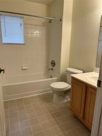 a bathroom with a toilet a sink and shower