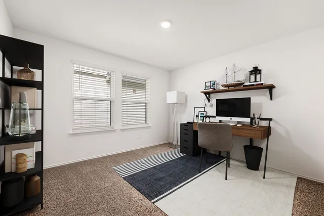 a workspace with furniture and a window