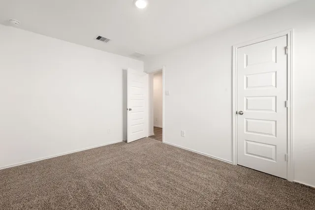 a bathroom with a toilet and a potted plant