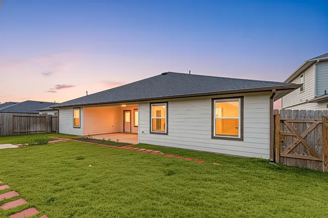 a view of a backyard with wooden fence