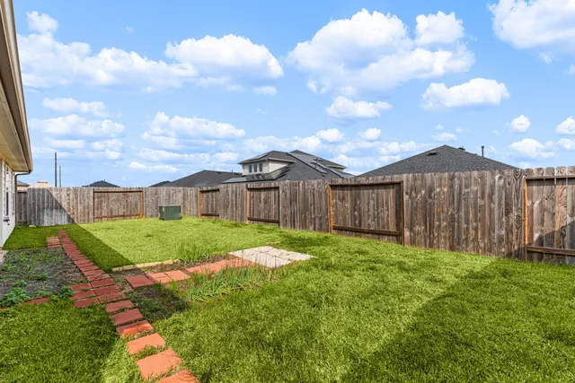 an aerial view of a house with swimming pool and lake view