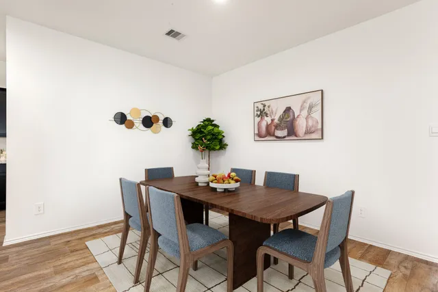 a dining room with furniture and wooden floor