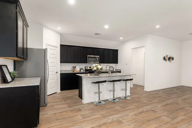 a kitchen with stainless steel appliances a sink stove and refrigerator