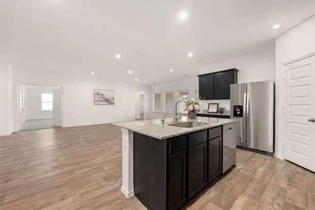 a kitchen with a sink a counter top space and stainless steel appliances