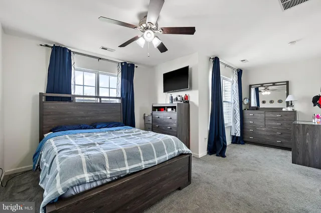 a bedroom with a bed and a tv on the dresser