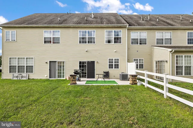 a view of a house with backyard sitting area and garden
