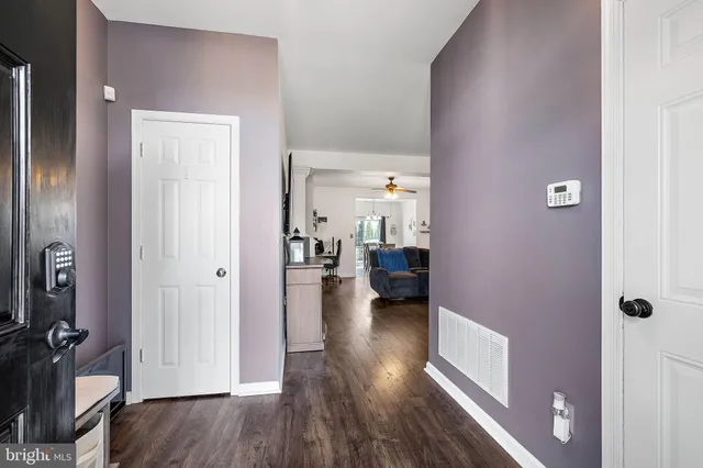 a view of a room with wooden floor furniture and a bathroom