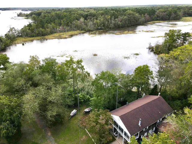 a view of house with yard and lake view