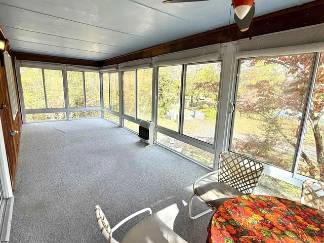 a spacious bedroom with a large bed and a large window