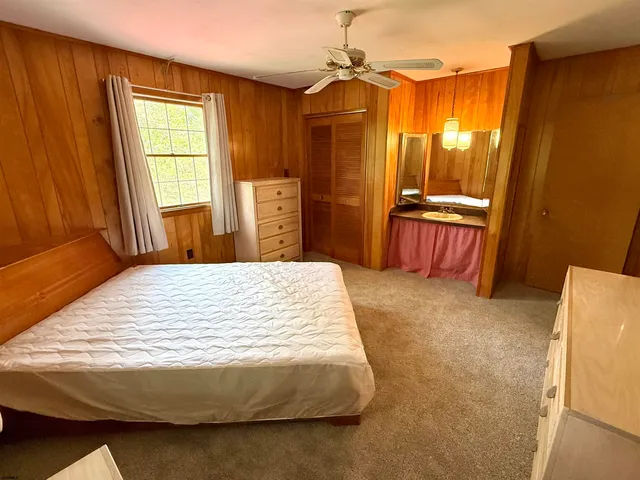 a bed sitting in a bedroom next to a window