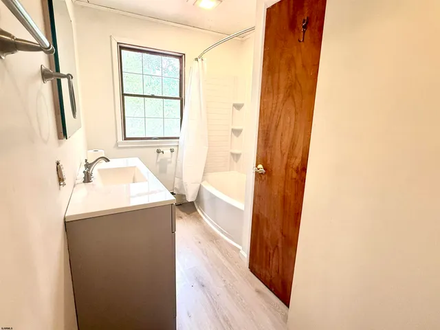 a bathroom with a sink a mirror and a bathtub