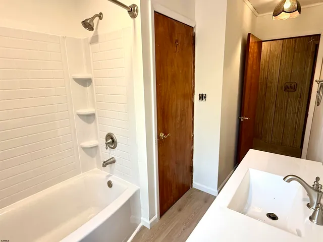a bathroom with a tub and shower