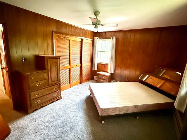 a bedroom with a bed and a dresser