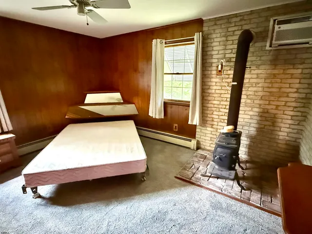 a bedroom with a bed and a ceiling fan