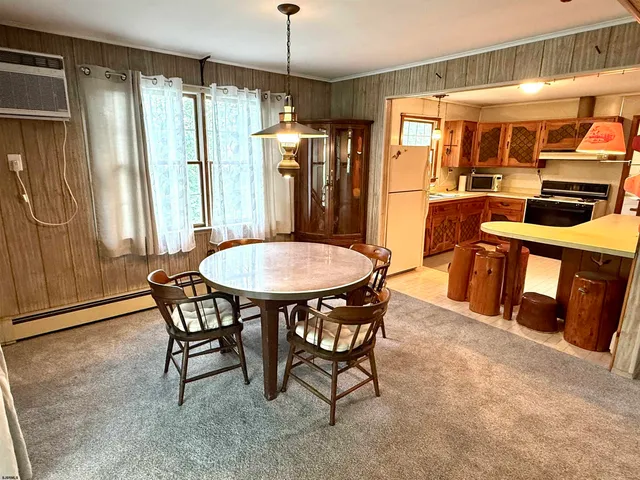 a view of a dining room with furniture and a chandelier