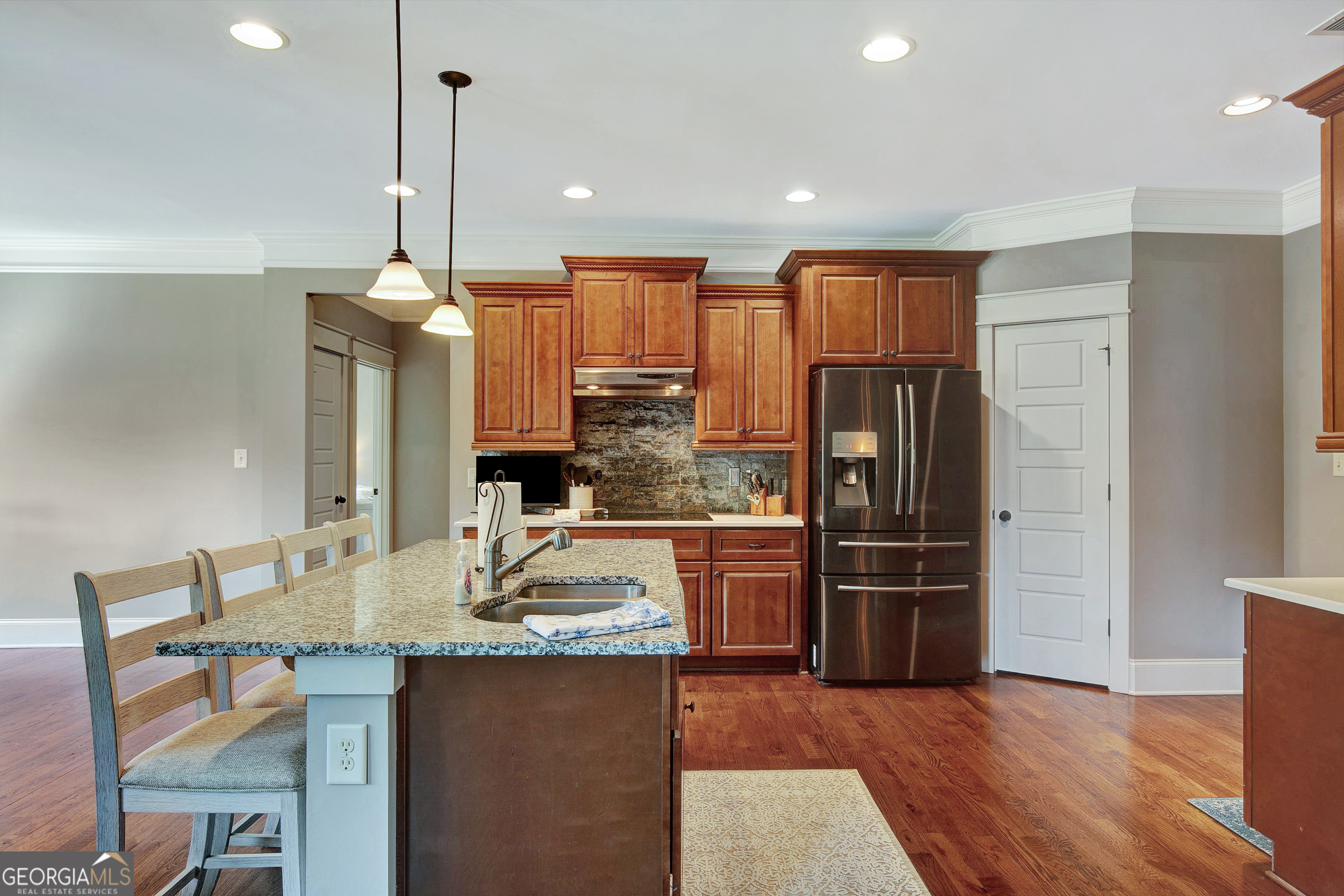 137 Kenmare Row Tyrone, GA 30290 - Photo 21 of 54 a kitchen with stainless steel appliances granite countertop a refrigerator a sink and a stove
