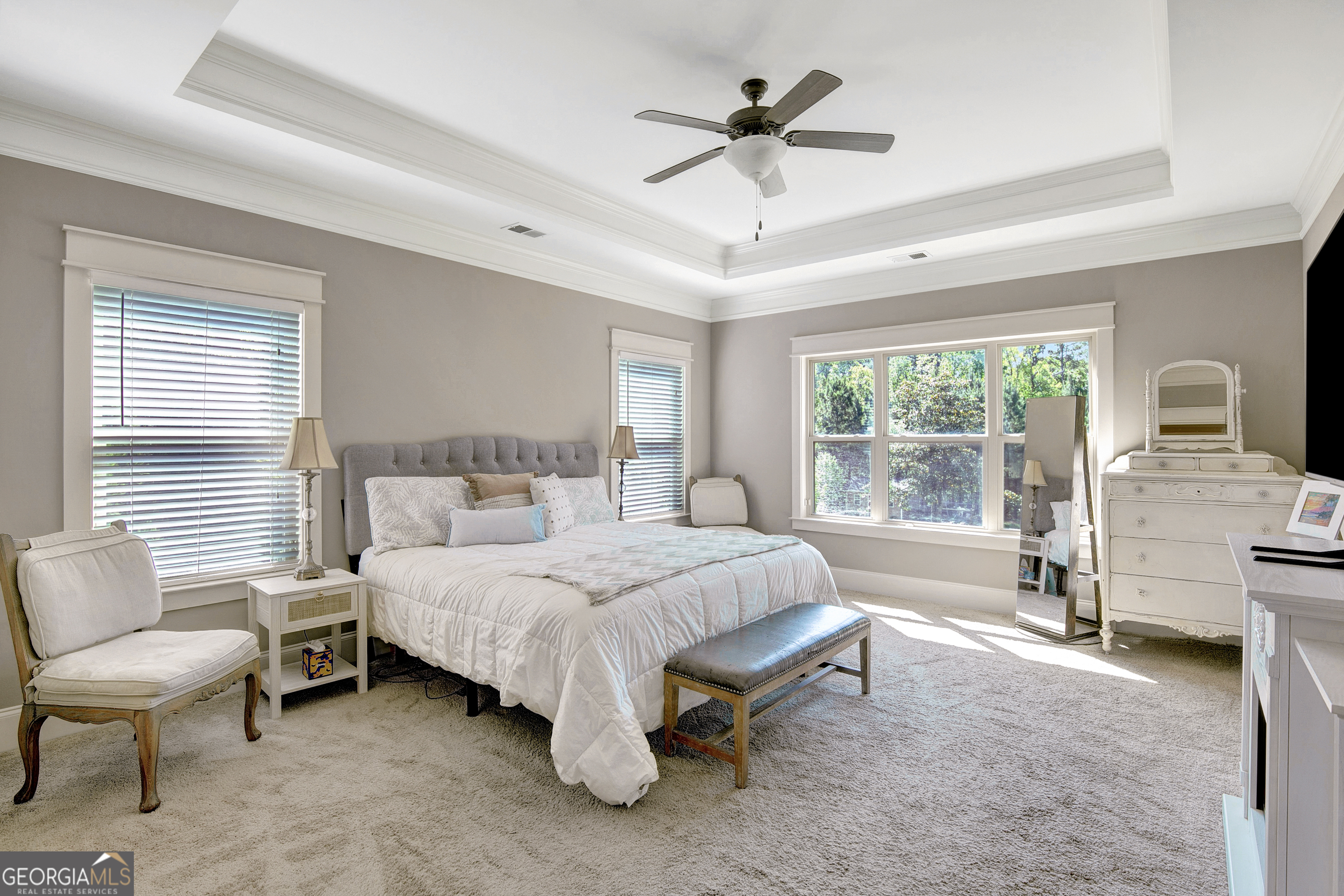 137 Kenmare Row Tyrone, GA 30290 - Photo 24 of 54 a spacious bedroom with a bed a couch and large window