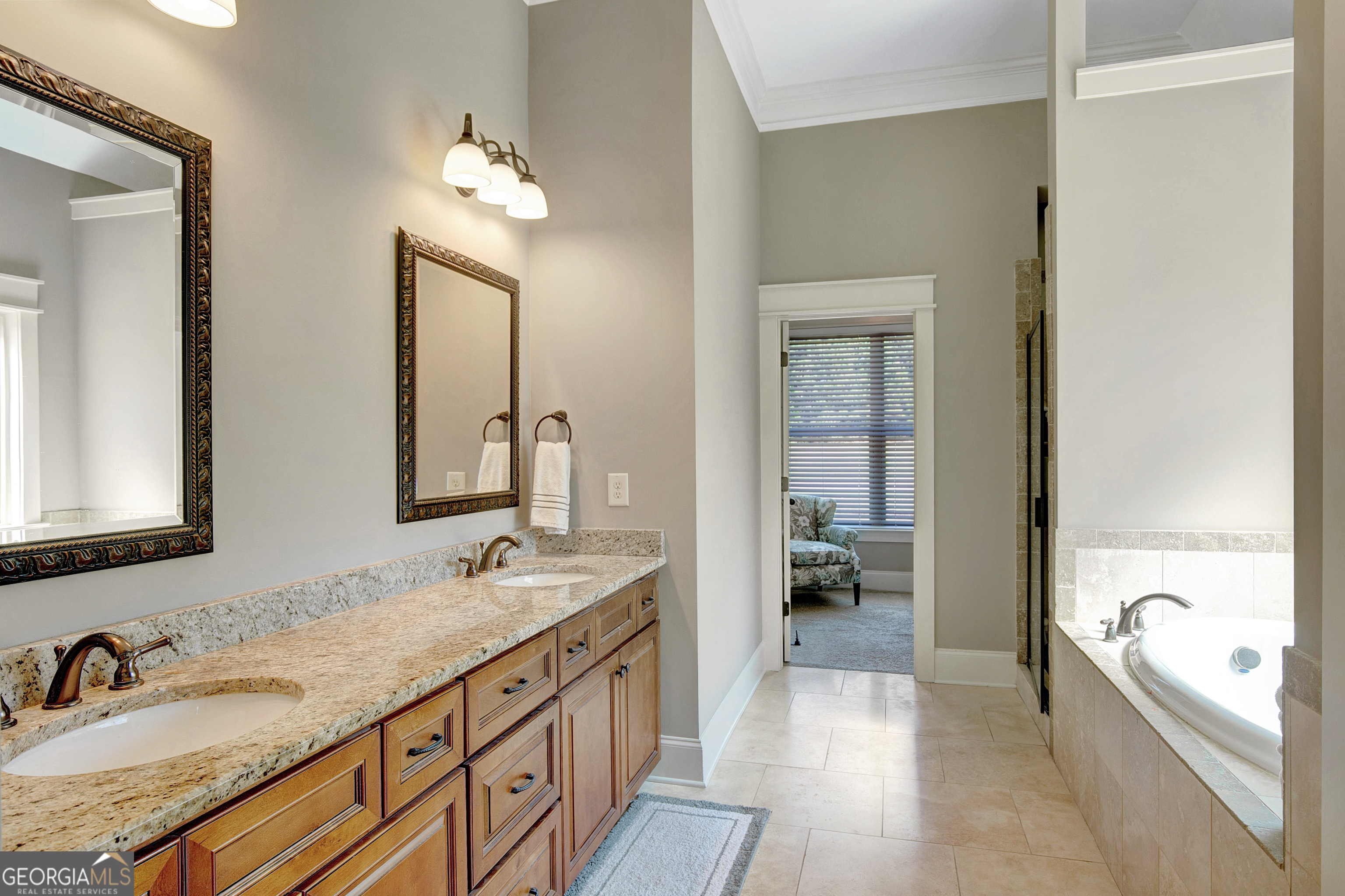 137 Kenmare Row Tyrone, GA 30290 - Photo 28 of 54 a spacious bathroom with a granite countertop tub a double vanity sink and a mirror