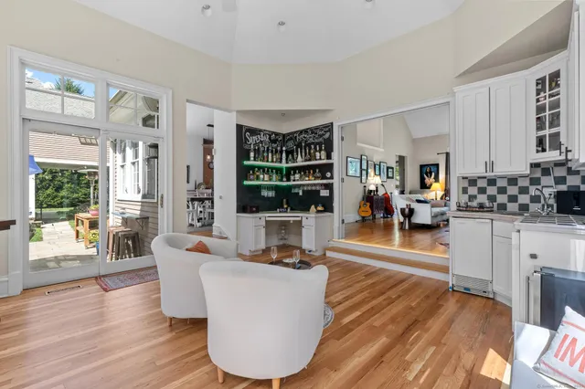 a living room with furniture a wooden floor and a large window