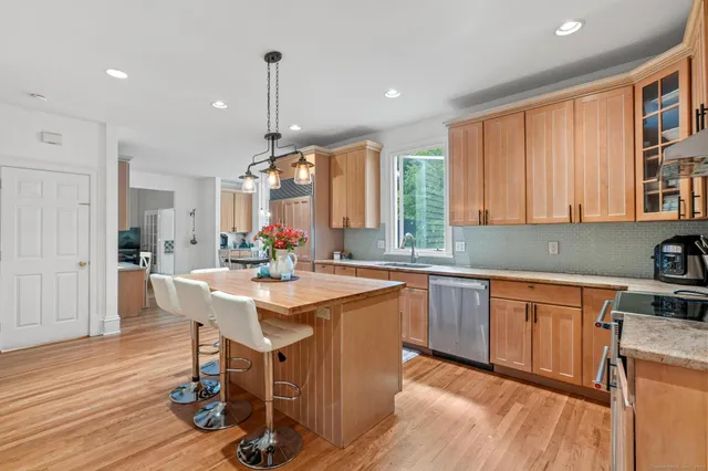 a kitchen with stainless steel appliances granite countertop counter space a sink and a refrigerator