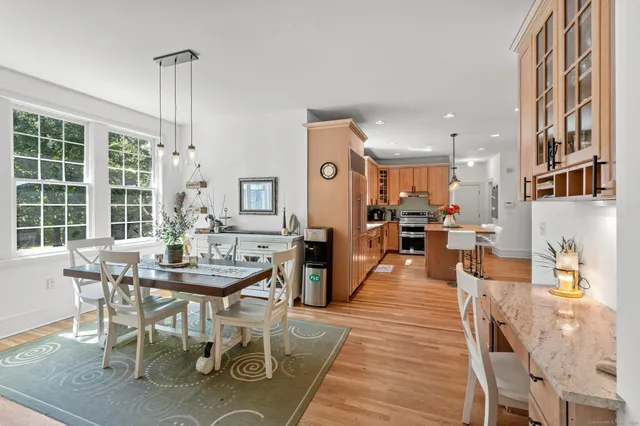 a view of a dining room with furniture window and wooden floor