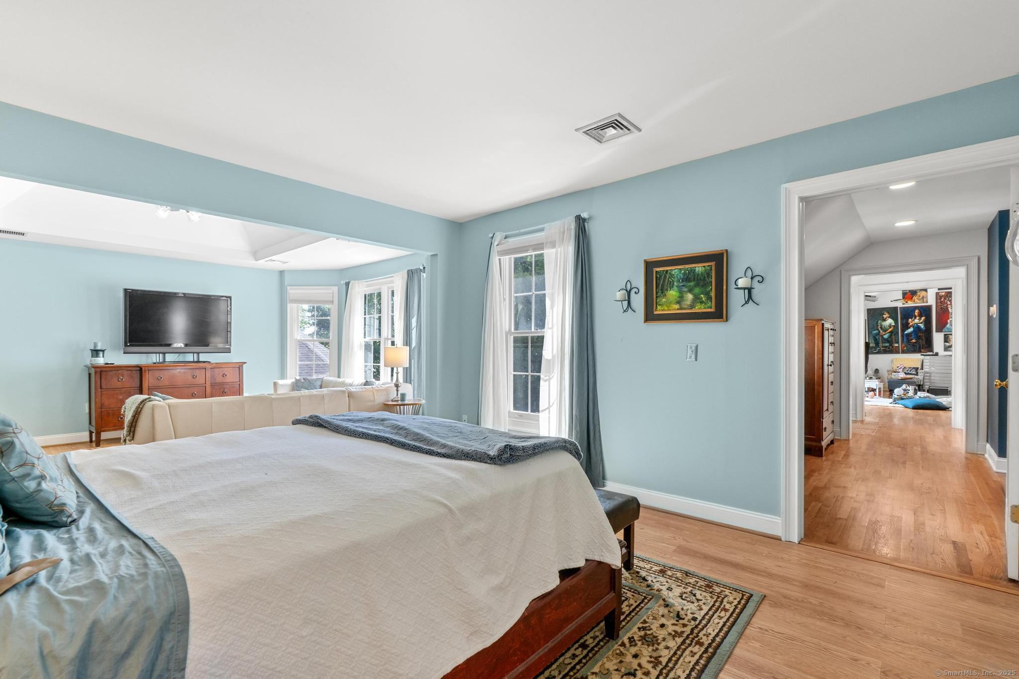 13 Orchard Hill Road Norwalk, CT 06851 - Photo 23 of 40 a spacious bedroom with a bed and a flat screen tv