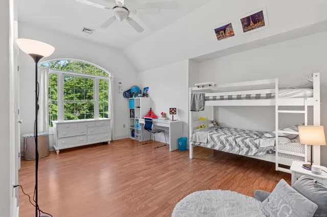 a bedroom with bunk bed and a window