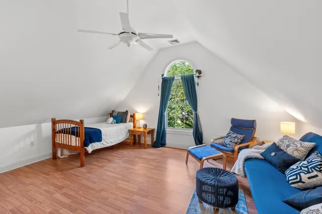 a bedroom with furniture and a window