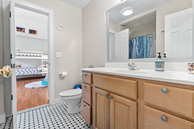 a bathroom with a sink toilet and a mirror