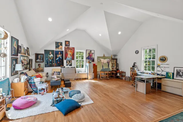 a living room with lots of furniture and a wooden floor