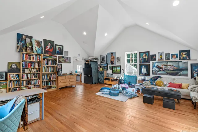 a living room with lots of furniture and wooden floor