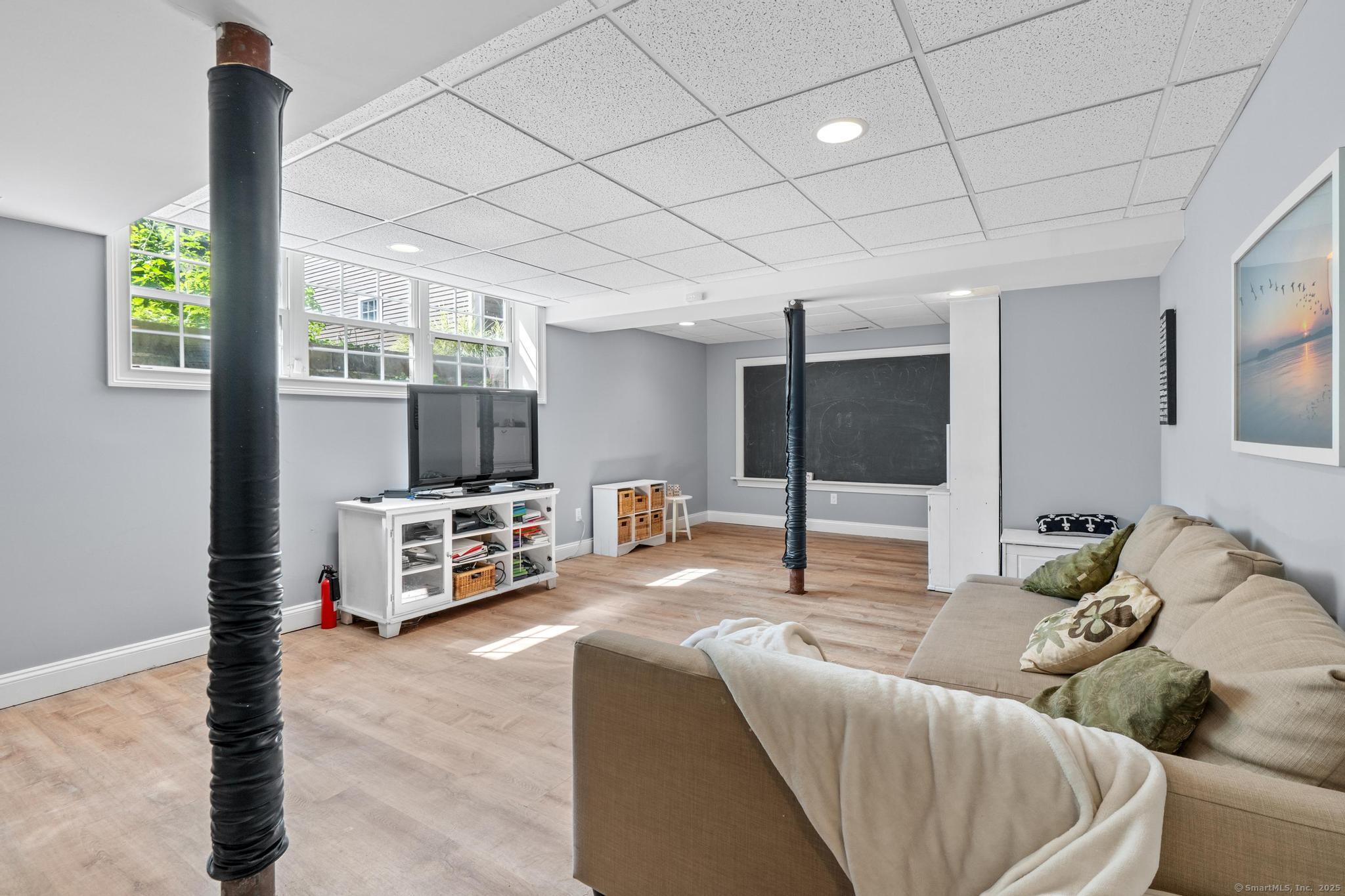 13 Orchard Hill Road Norwalk, CT 06851 - Photo 33 of 40 a living room with furniture and a flat screen tv