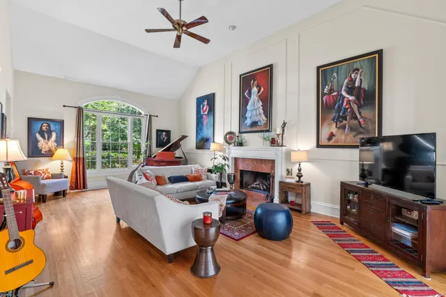 a living room with furniture a fireplace and a flat screen tv