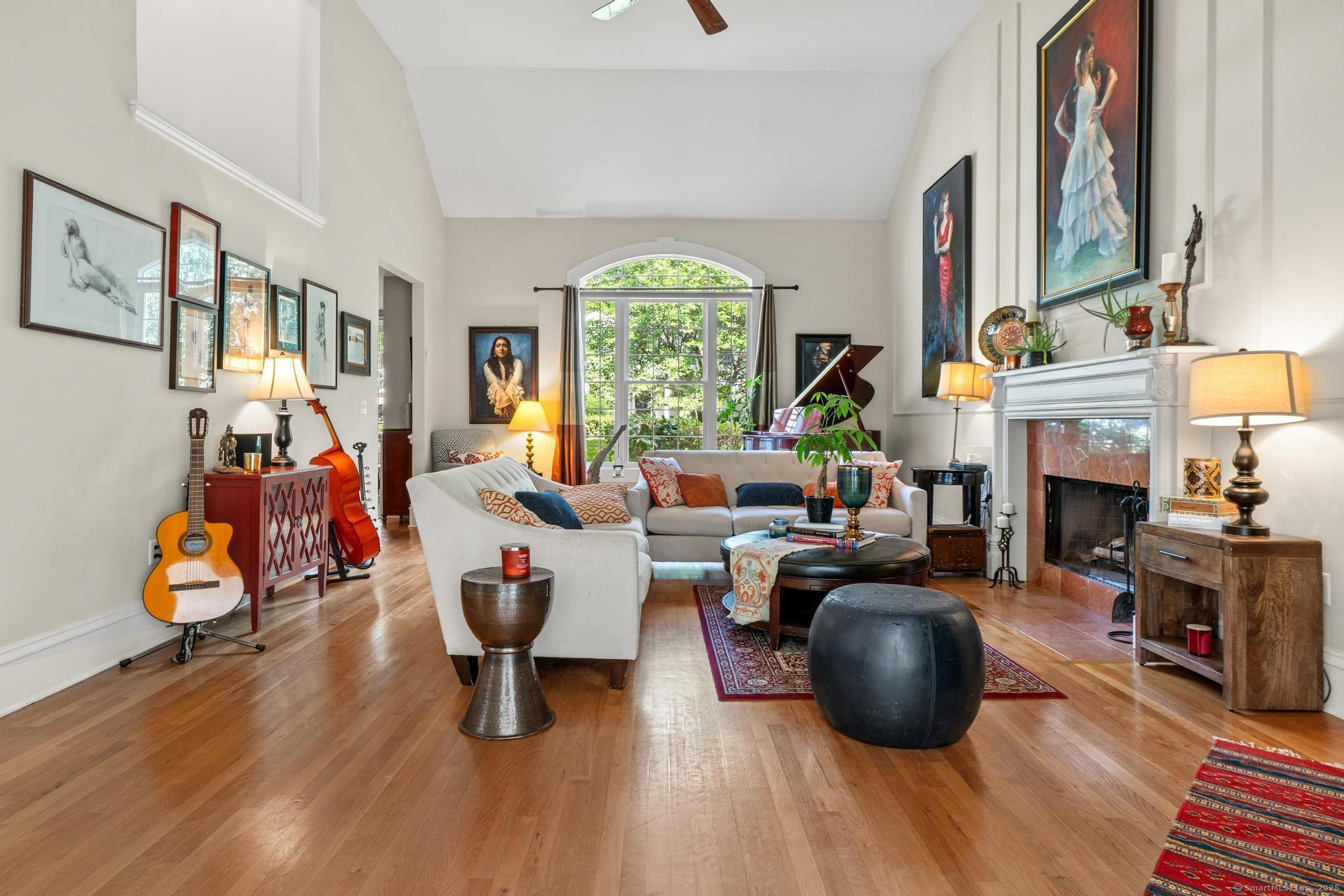 13 Orchard Hill Road Norwalk, CT 06851 - Photo 10 of 40 a living room with furniture a fireplace and a large window