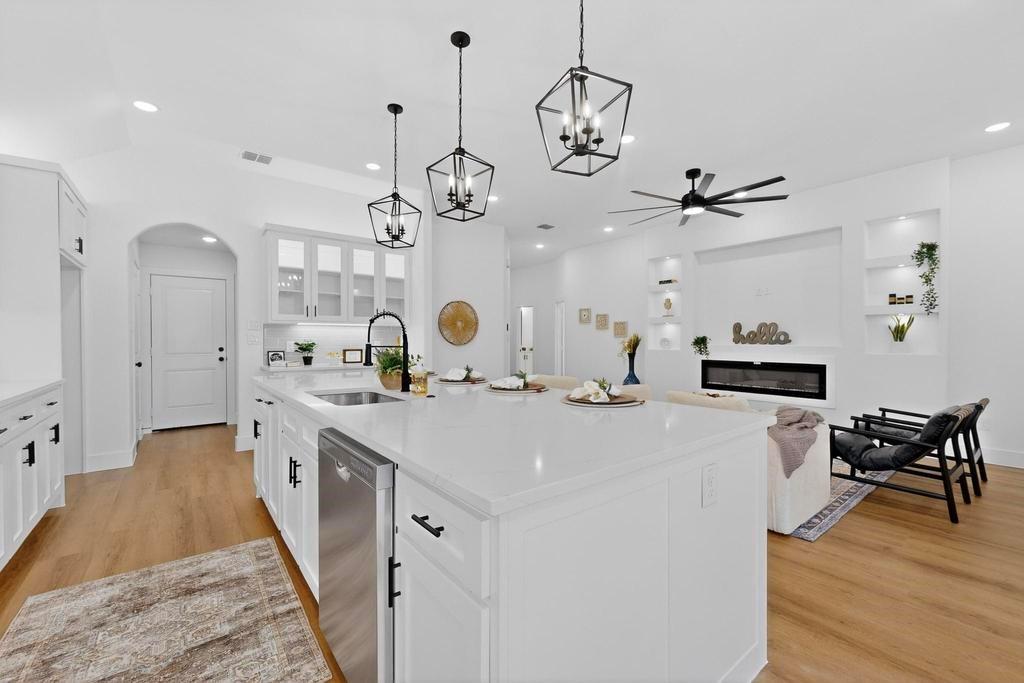 101 Boone Street Edgewood, TX 75117 - Photo 12 of 40 a large kitchen with kitchen island a lot of counter space and a chandelier