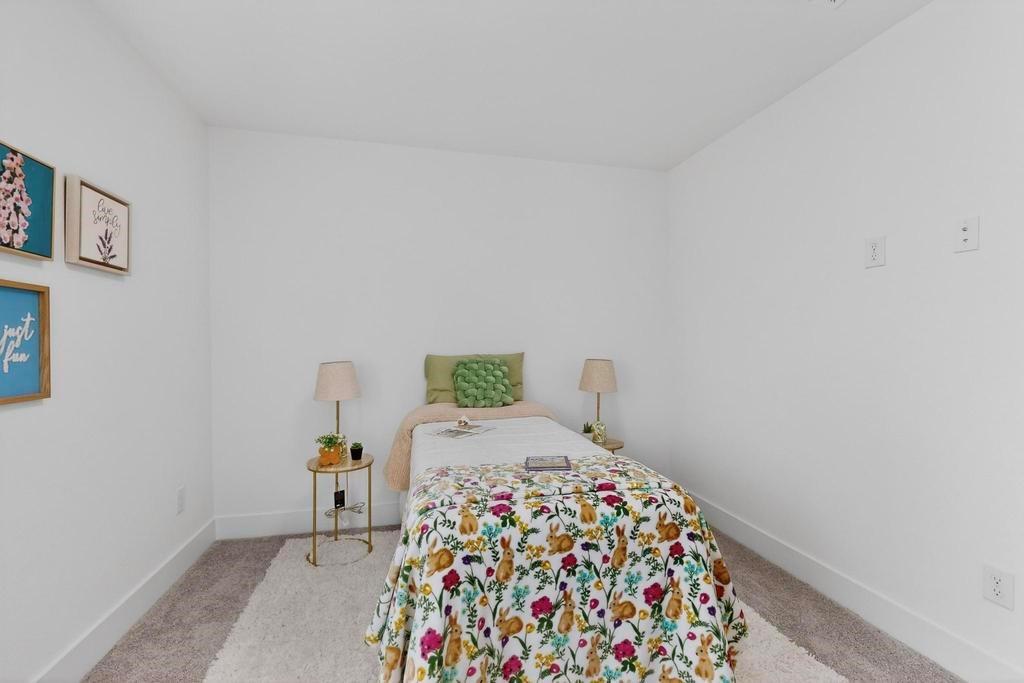 101 Boone Street Edgewood, TX 75117 - Photo 29 of 40 a bedroom with a bed and a lamp on the dresser