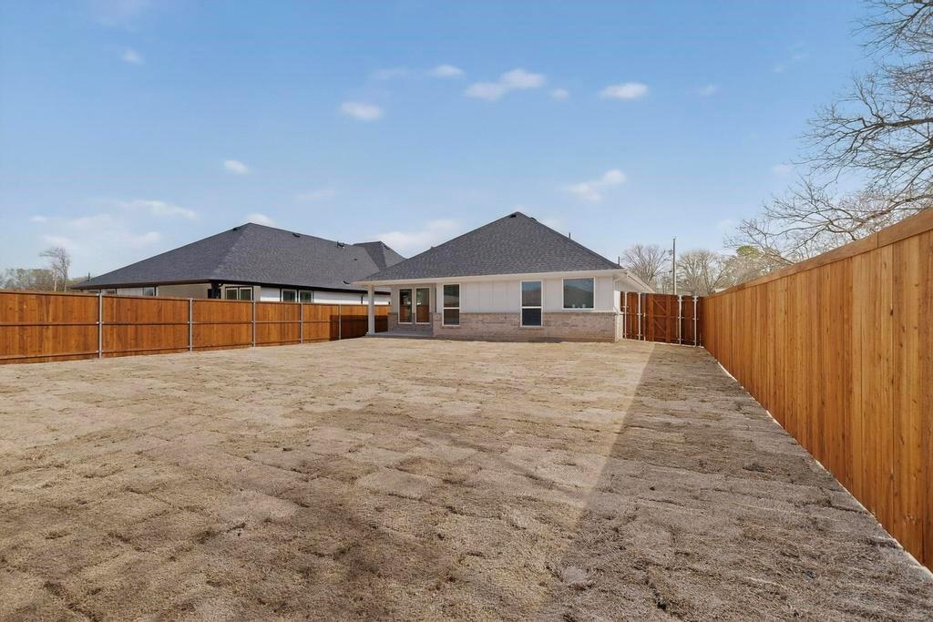 101 Boone Street Edgewood, TX 75117 - Photo 36 of 40 a view of a house with a yard and wooden fence