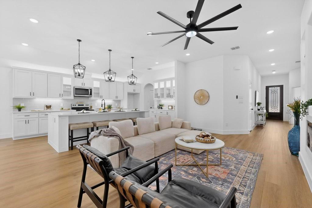 101 Boone Street Edgewood, TX 75117 - Photo 9 of 40 a very nice looking dining room with kitchen island stainless steel appliances furniture a dining table and a chandelier