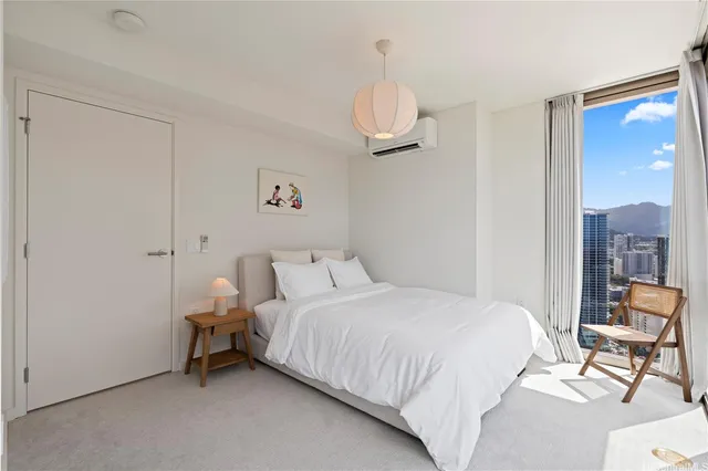 a bathroom with a granite countertop sink a toilet a mirror and shower