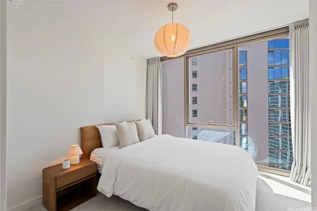 a bedroom with a bed mirror and window