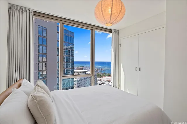 a bedroom with a bed and a chandelier