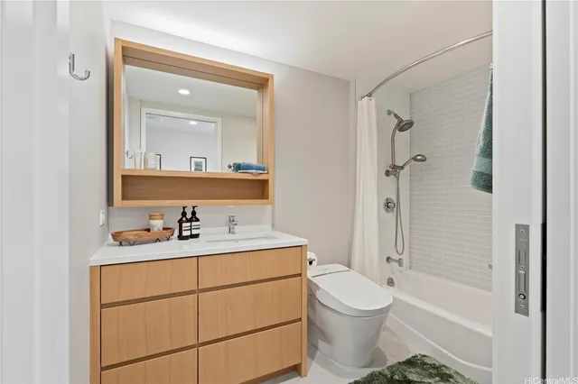 a bathroom with a sink toilet a mirror and shower