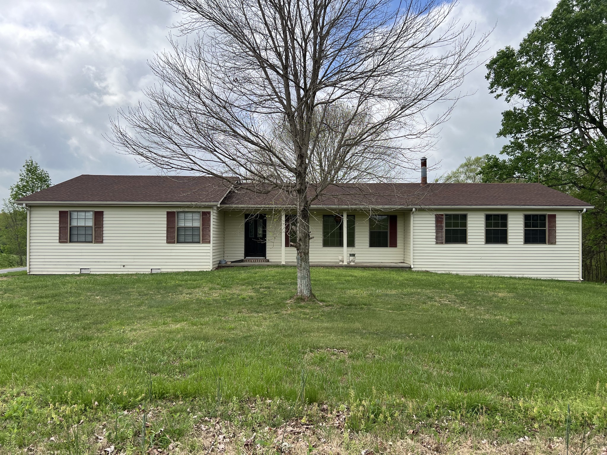 13254 Galen Road Lafayette, TN 37083 - Photo 1 of 19 a front view of a house with a garden