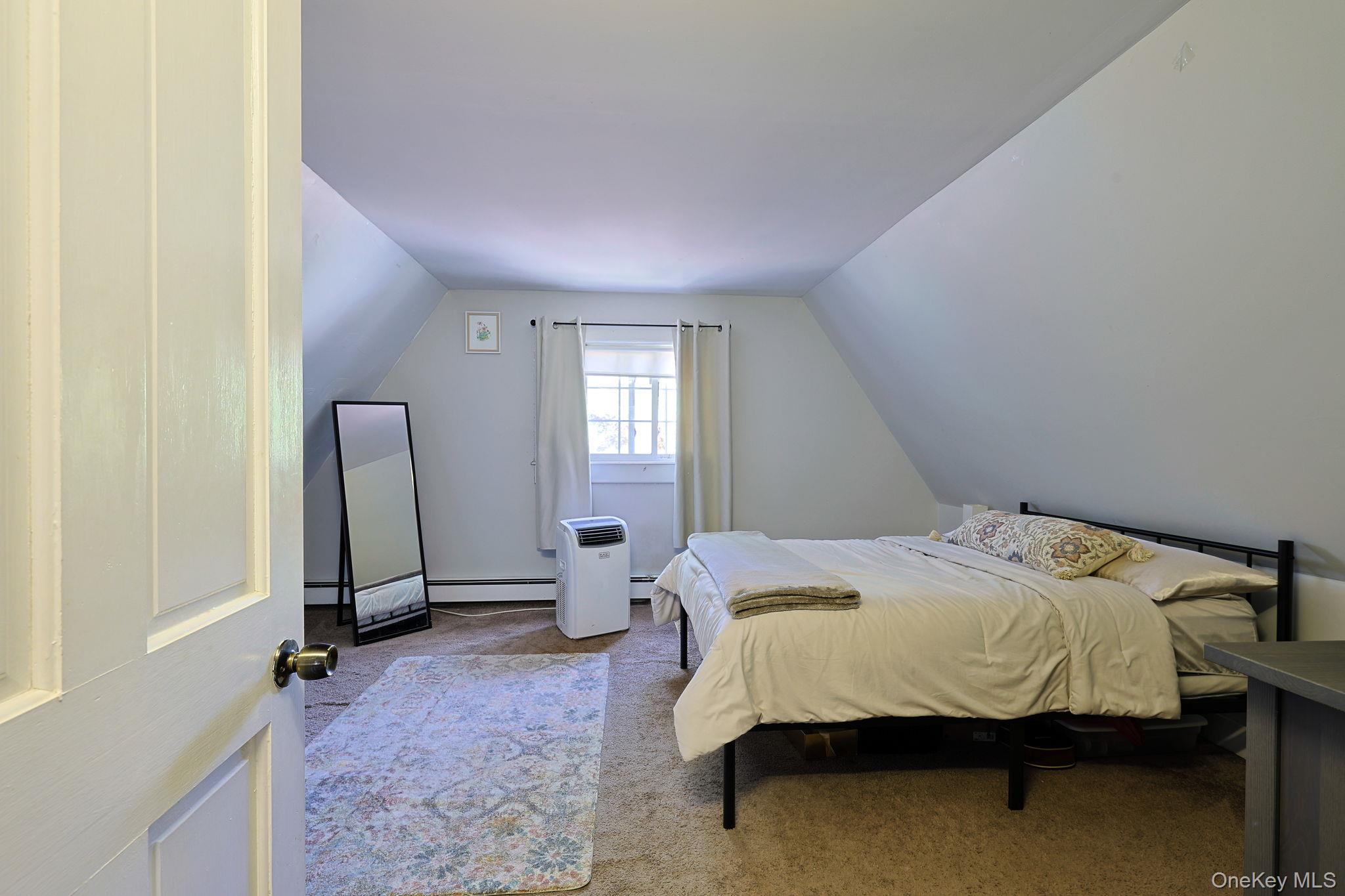 9 Library Road Tuxedo Park, NY 10987 - Photo 25 of 37 Carpeted room with sloped ceilings and a single window