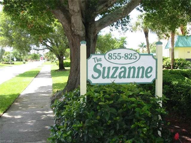 a view of water heater and room with wooden floor